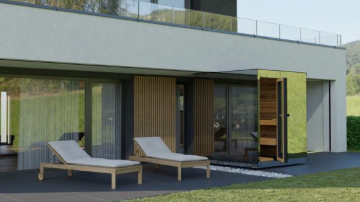 Modern house exterior with lounge chairs and a glass door.