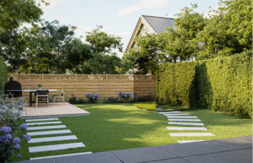 Backyard with garden furniture, plants, and a wooden fence.